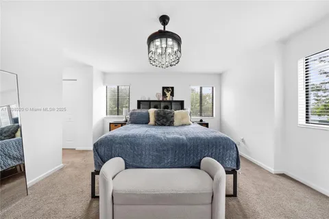 a bed room with a bed and a chandelier