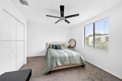 a bedroom with a bed a dresser and a window