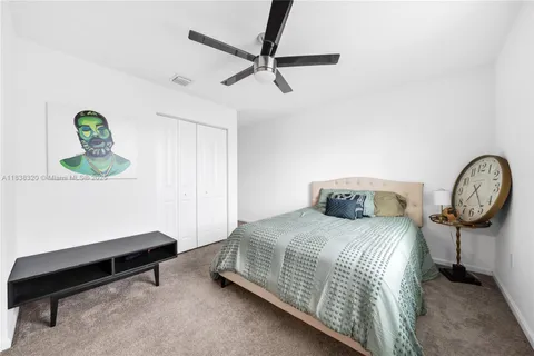 a bedroom with a bed a window and a chandelier