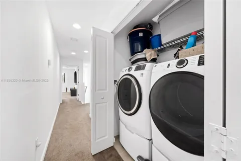 a view of a hallway with washer and dryer