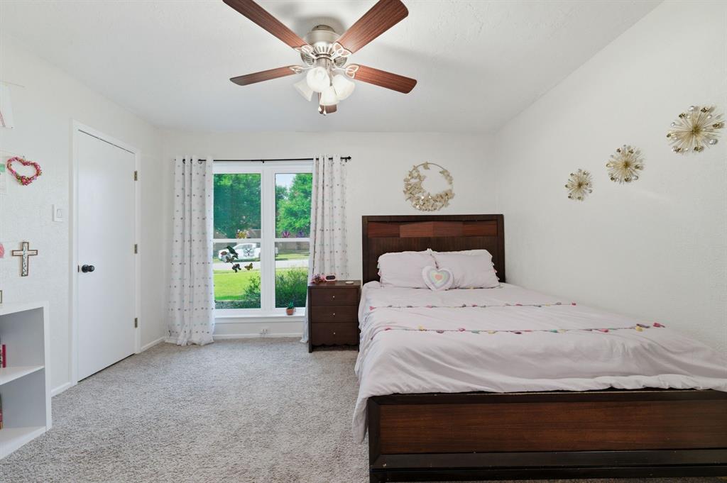 224 Overcrest Drive Benbrook, TX 76126 - Photo 22 of 39 a bedroom with a bed and a chandelier
