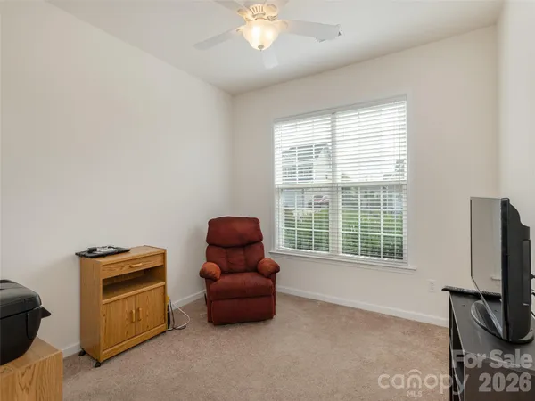 a room with furniture a flat screen tv and a window