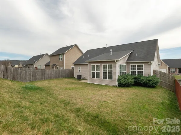 a view of a house with a yard and sitting area
