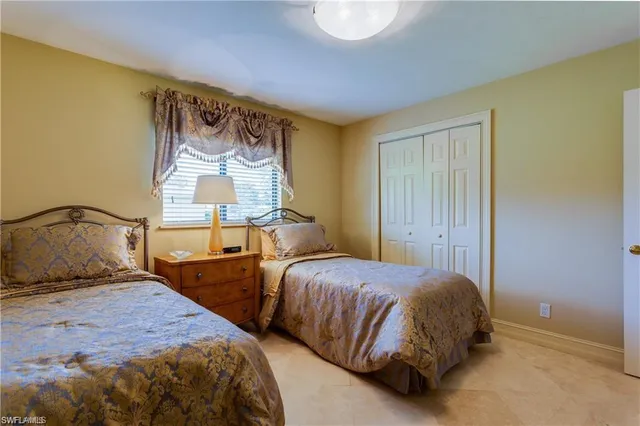 a bedroom with two beds and a window