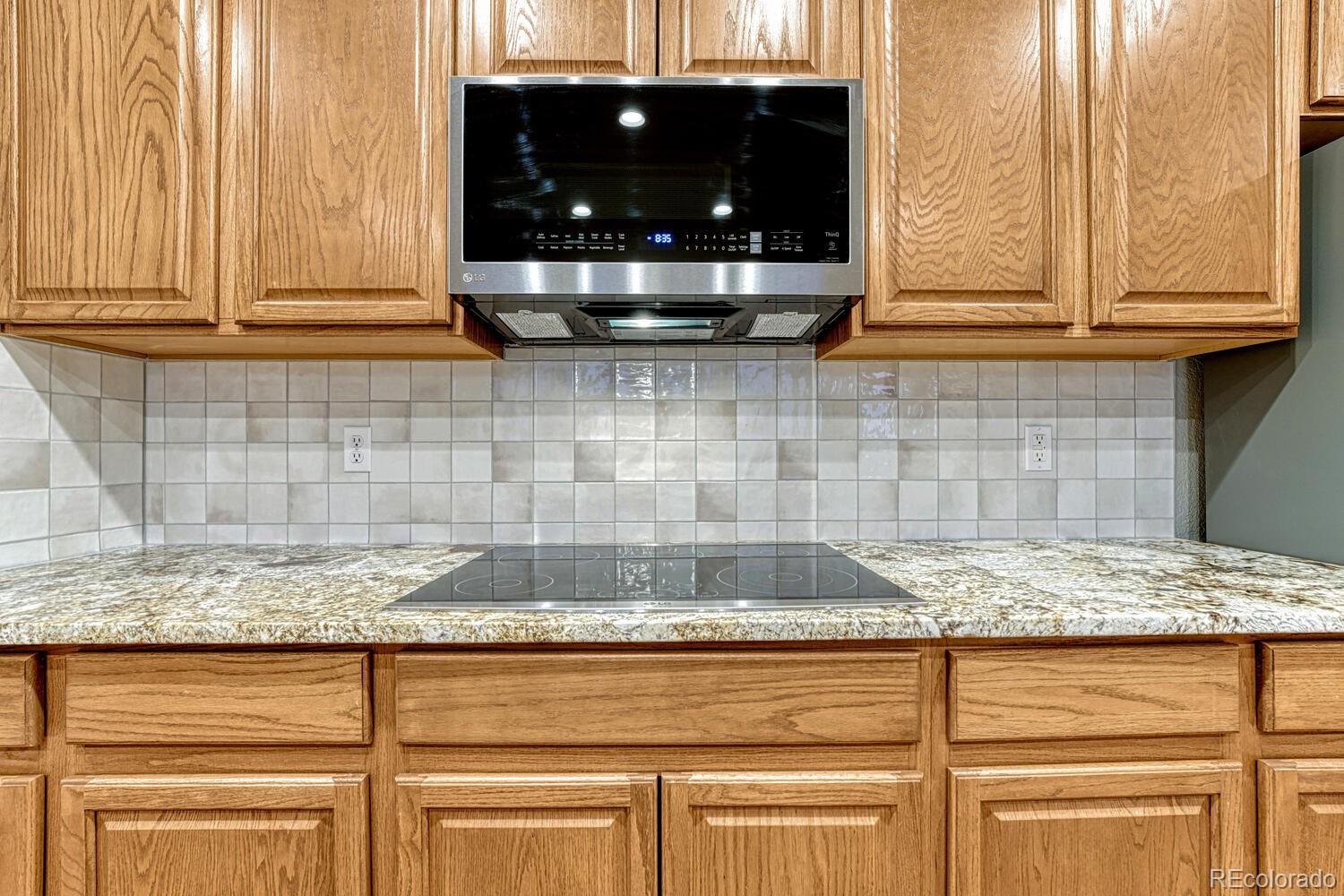 12350 Turquoise Terrace Street Castle Pines, CO 80108 - Photo 15 of 50 a kitchen with granite countertop white cabinets and a sink