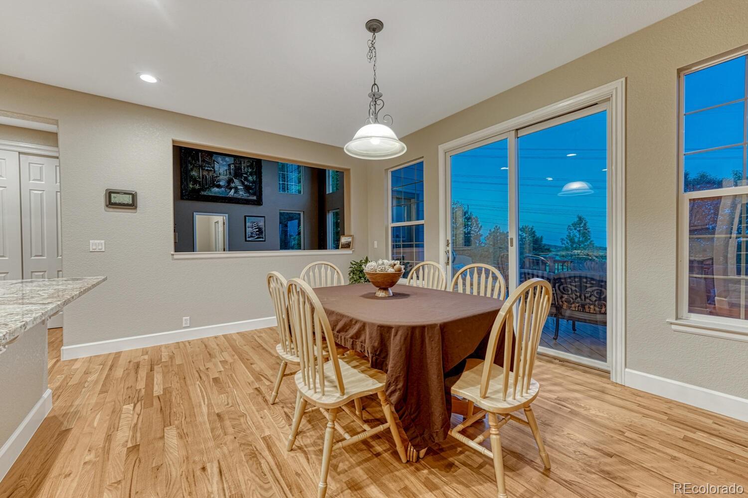 12350 Turquoise Terrace Street Castle Pines, CO 80108 - Photo 16 of 50 a view of a dining room with furniture window and wooden floor
