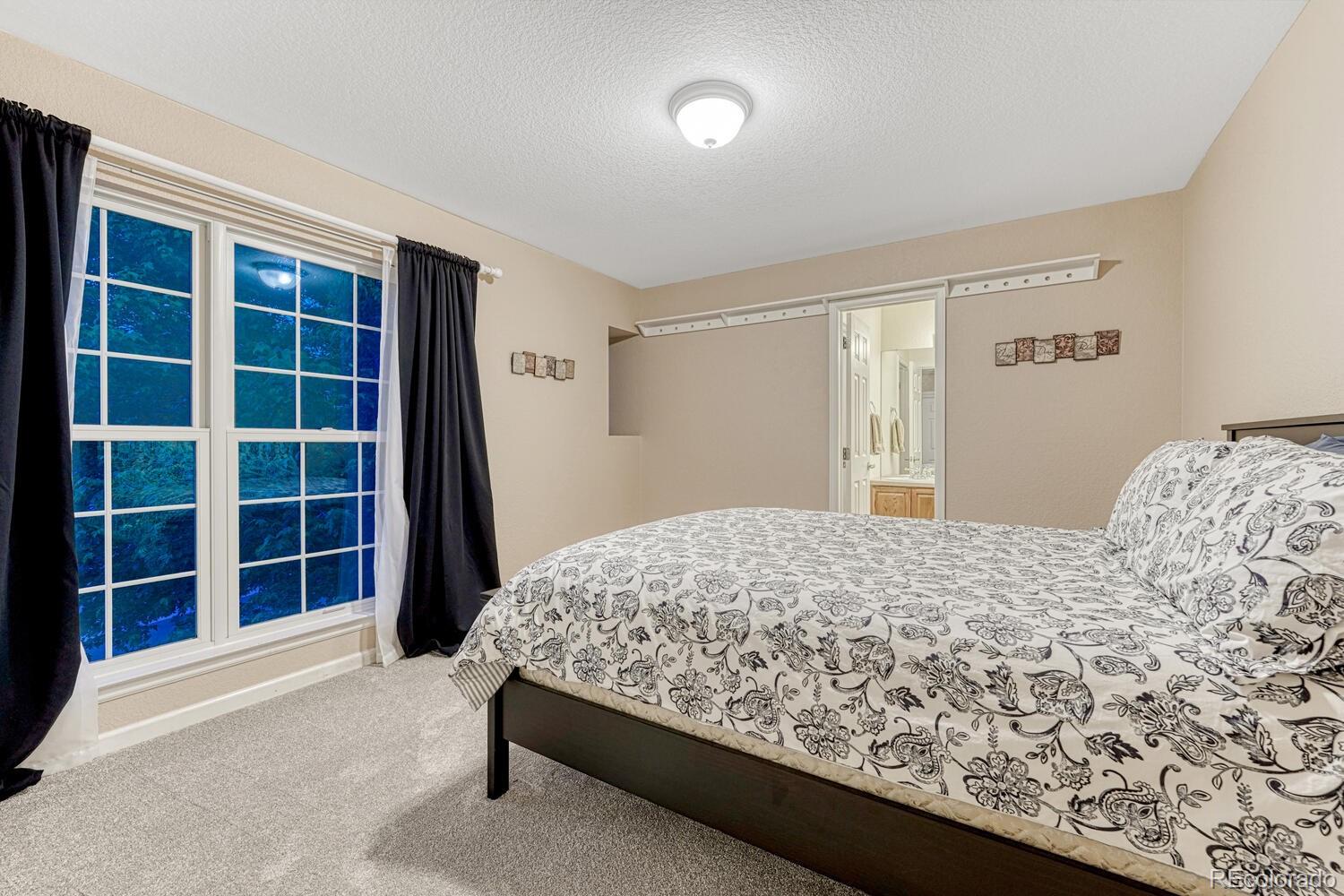 12350 Turquoise Terrace Street Castle Pines, CO 80108 - Photo 24 of 50 a bedroom with a bed and a window