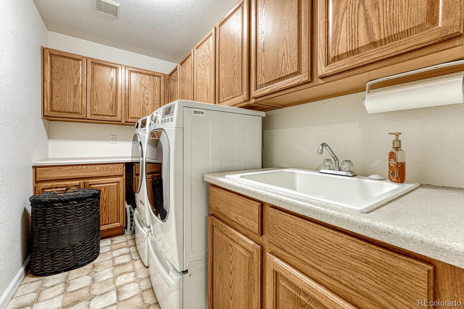 12350 Turquoise Terrace Street Castle Pines, CO 80108 - Photo 29 of 50 a white refrigerator freezer sitting inside of a kitchen