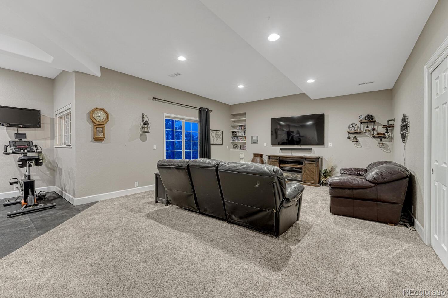 12350 Turquoise Terrace Street Castle Pines, CO 80108 - Photo 30 of 50 a living room with furniture and a flat screen tv