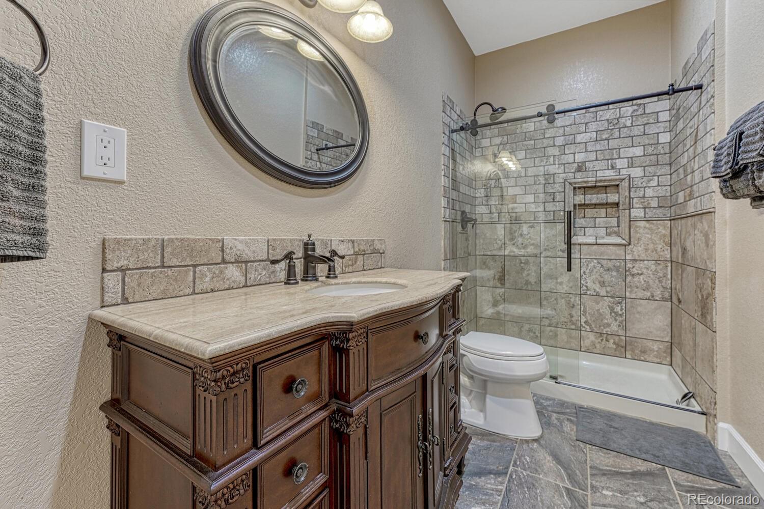 12350 Turquoise Terrace Street Castle Pines, CO 80108 - Photo 34 of 50 a bathroom with a sink toilet and shower