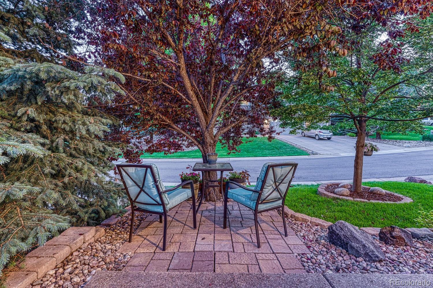 12350 Turquoise Terrace Street Castle Pines, CO 80108 - Photo 5 of 50 a table and chairs in a garden
