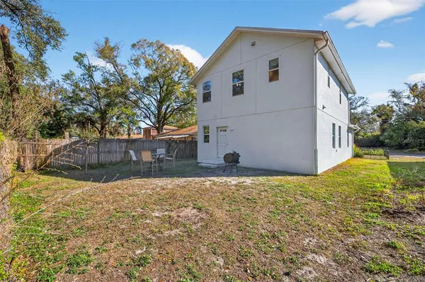 a view of a backyard with sitting area