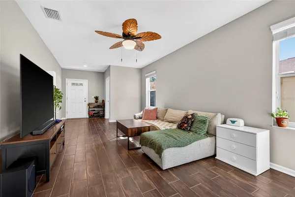 a living room with furniture and wooden floor