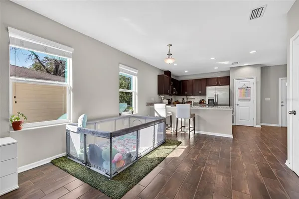 a kitchen with stainless steel appliances granite countertop a refrigerator and a stove top oven