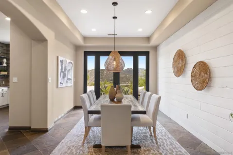 a kitchen with stainless steel appliances kitchen island a table and chairs in it