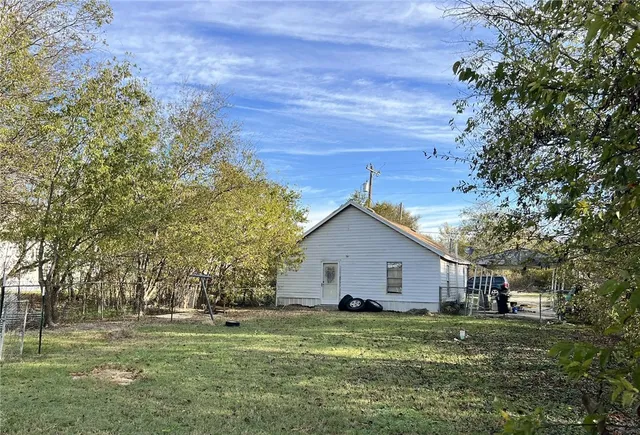 a front view of house with a garden