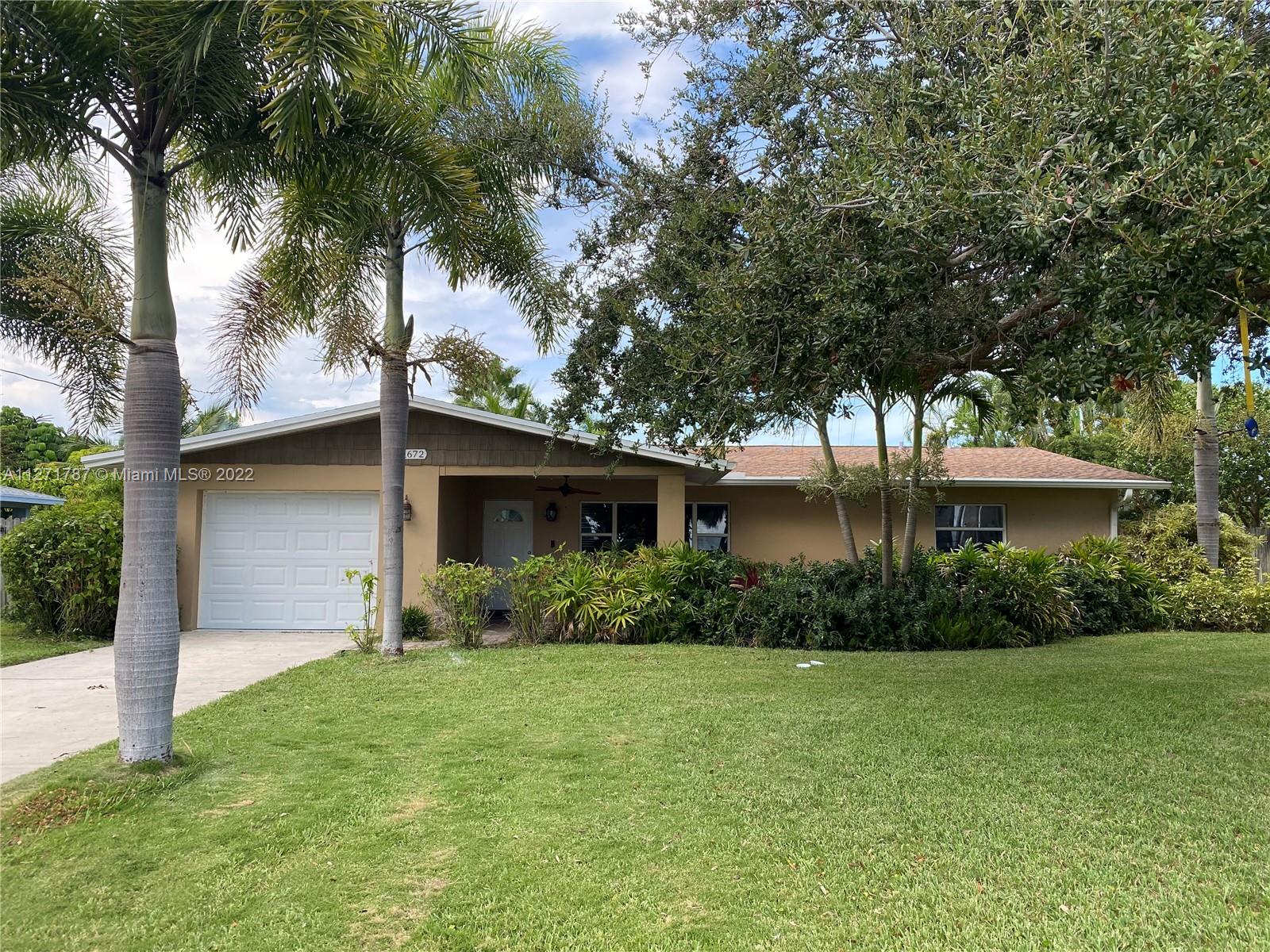 1672 Thumb Point Drive Fort Pierce, FL 34949 - Photo 1 of 29 a front view of a house with garden