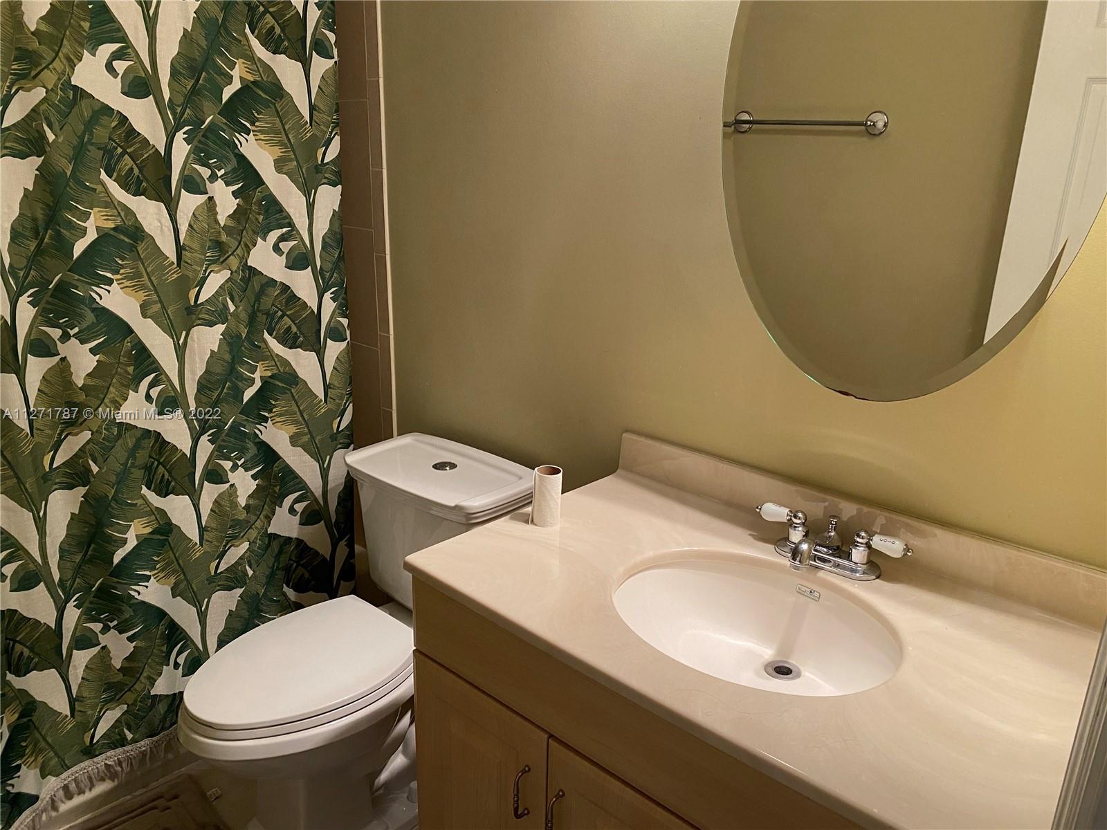 1672 Thumb Point Drive Fort Pierce, FL 34949 - Photo 15 of 29 a bathroom with a sink a toilet and a mirror
