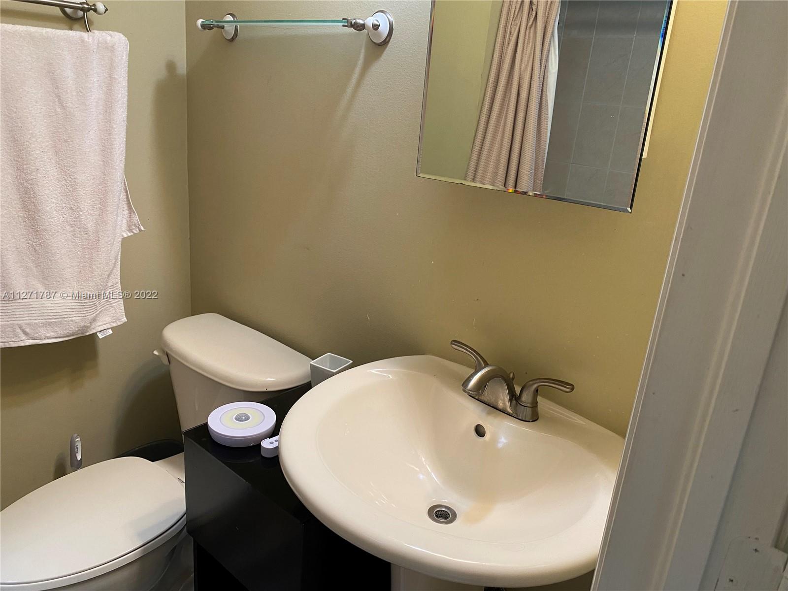 1672 Thumb Point Drive Fort Pierce, FL 34949 - Photo 21 of 29 a bathroom with a sink a toilet and a mirror