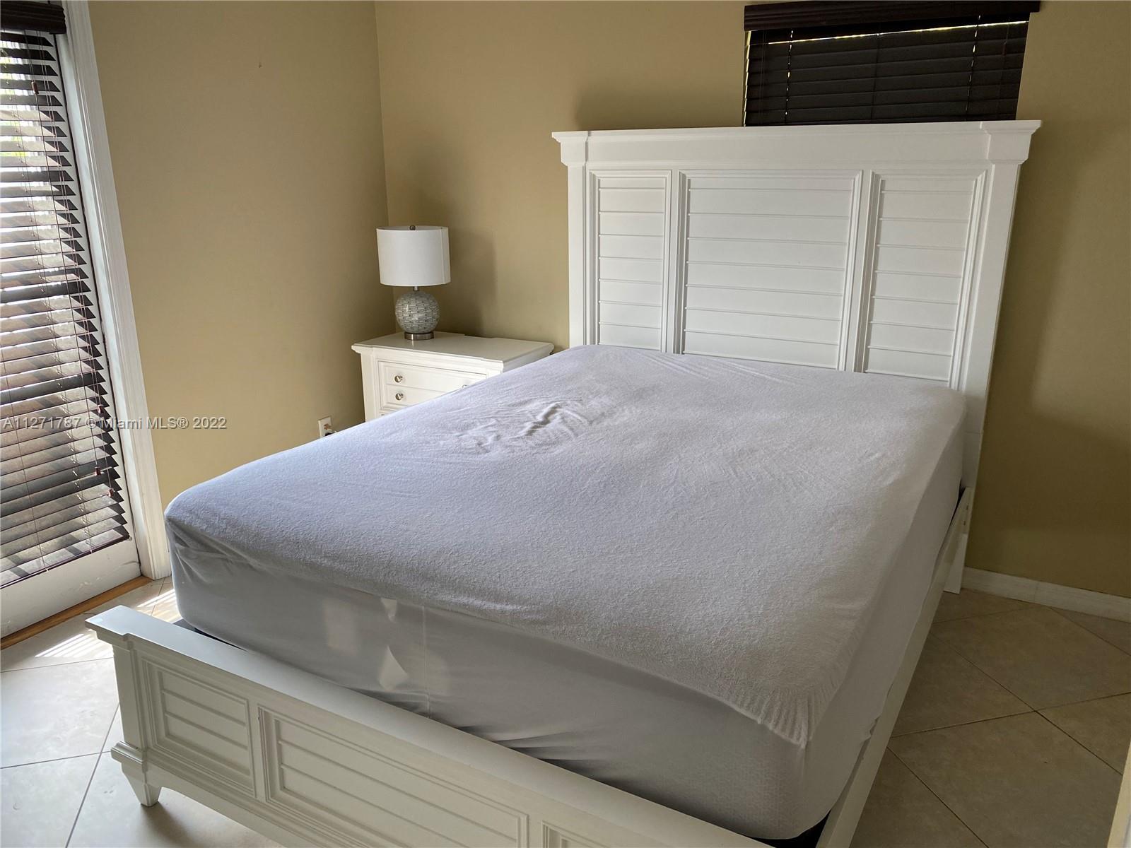 1672 Thumb Point Drive Fort Pierce, FL 34949 - Photo 24 of 29 a large bed sitting in a bedroom next to a window