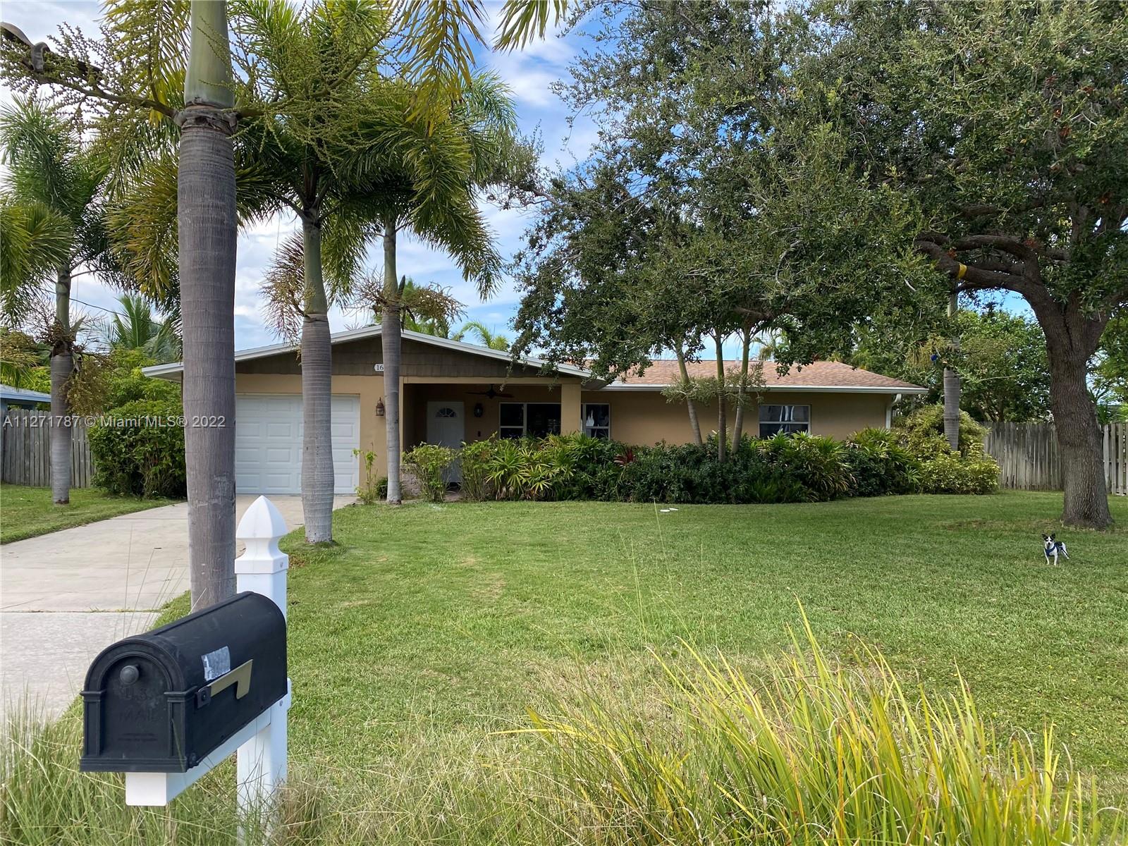 1672 Thumb Point Drive Fort Pierce, FL 34949 - Photo 4 of 29 a front view of a house with garden