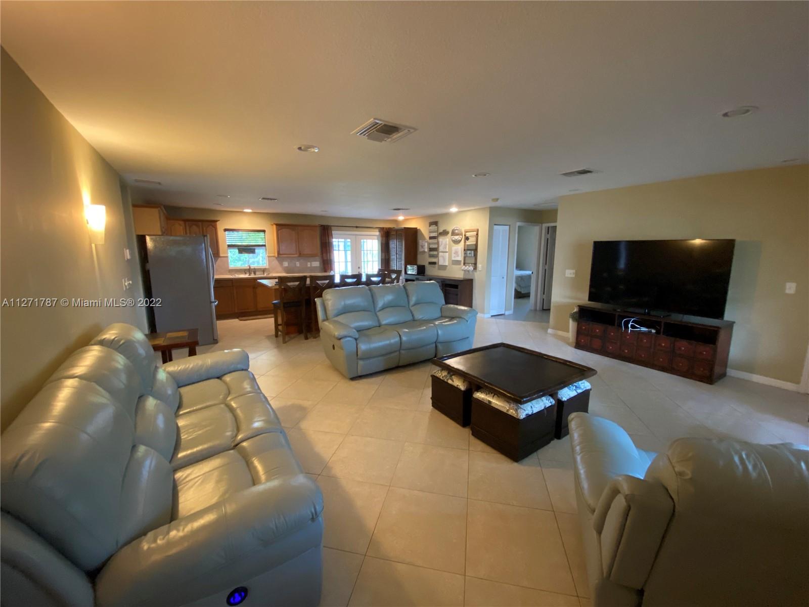 1672 Thumb Point Drive Fort Pierce, FL 34949 - Photo 6 of 29 a living room with furniture and a flat screen tv