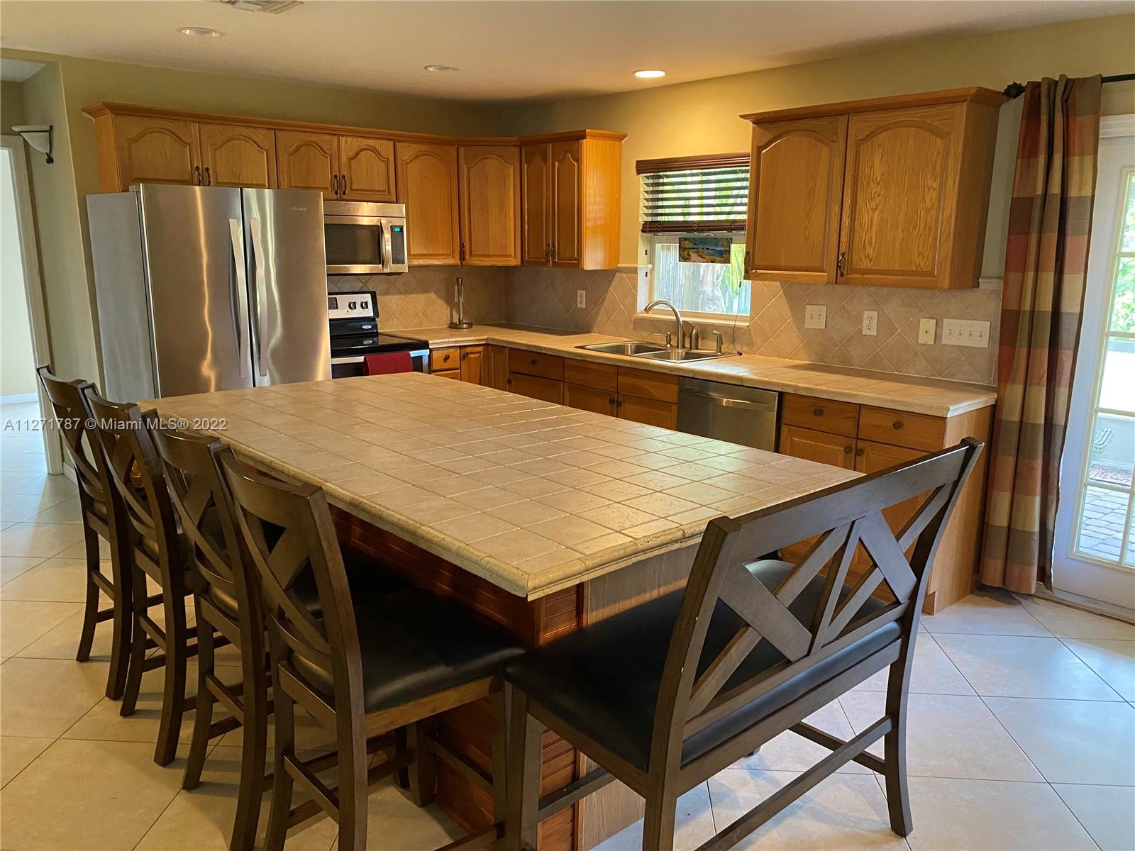 1672 Thumb Point Drive Fort Pierce, FL 34949 - Photo 7 of 29 a kitchen with stainless steel appliances stove microwave and refrigerator