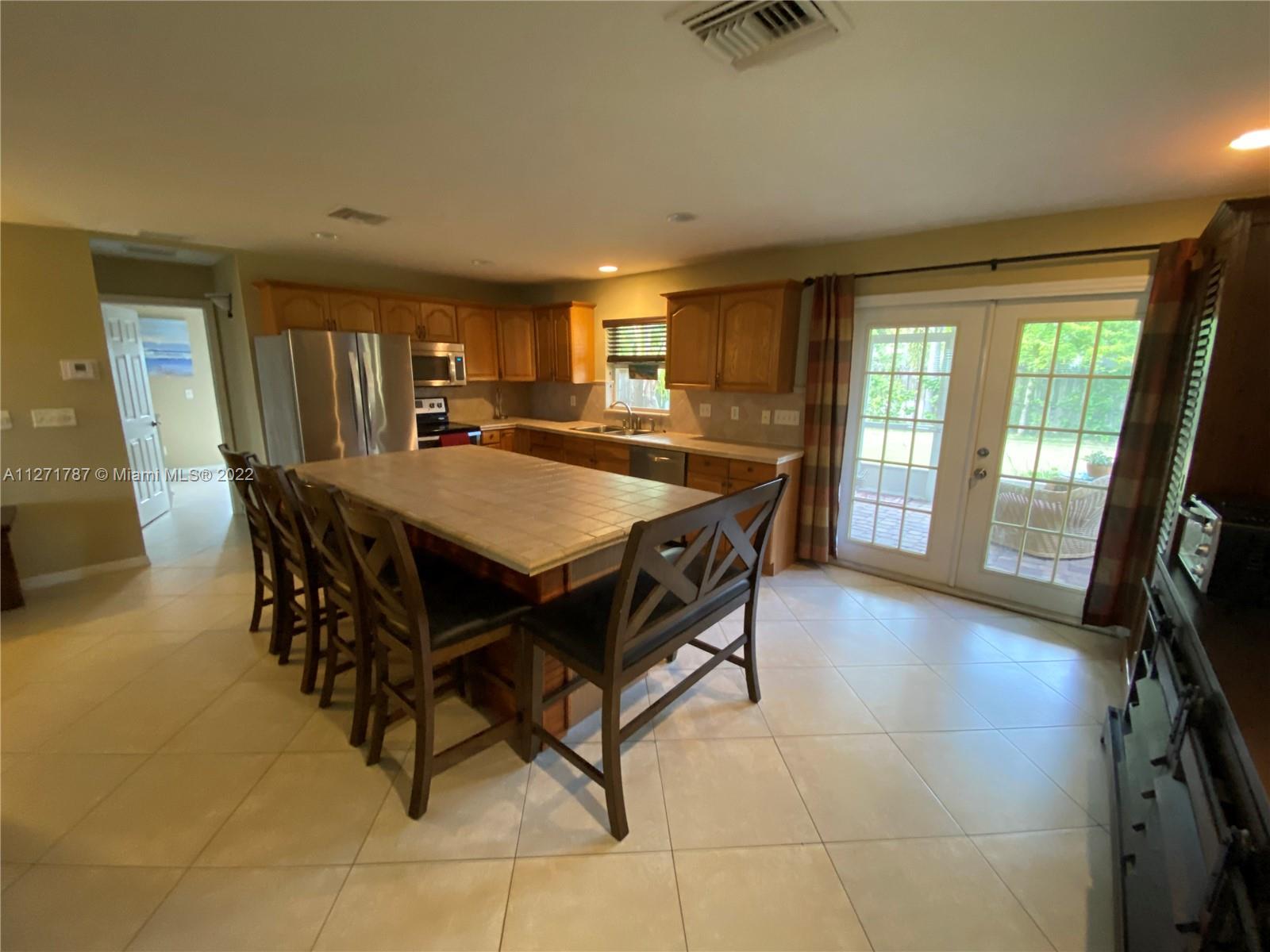 1672 Thumb Point Drive Fort Pierce, FL 34949 - Photo 8 of 29 a dining hall with stainless steel appliances granite countertop a stove a sink a dining table and chairs
