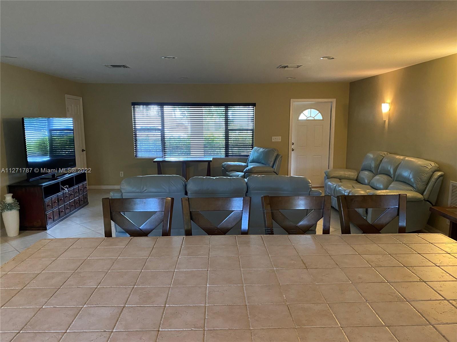 1672 Thumb Point Drive Fort Pierce, FL 34949 - Photo 9 of 29 a living room with furniture and a flat screen tv