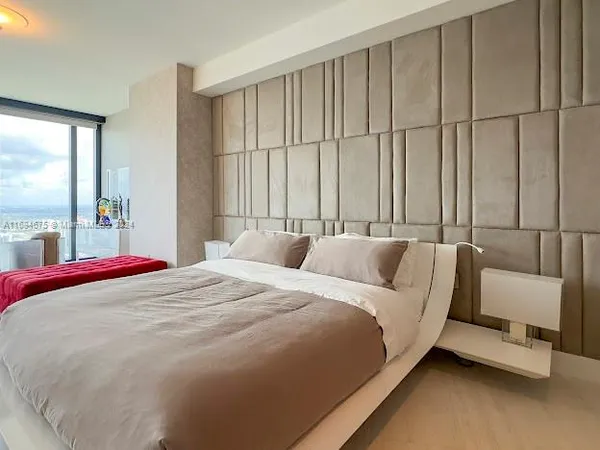 a bathroom with a tub a sink and a large mirror