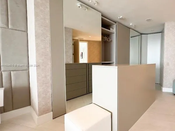 a bedroom with a bed and a mirror