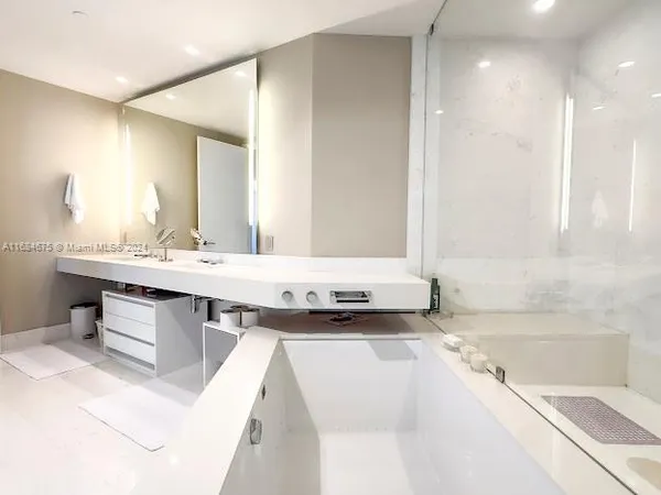 a white toilet sitting next to a bathroom sink