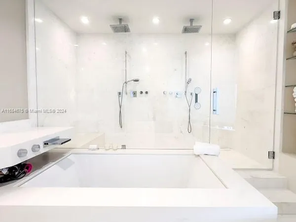 a spacious bedroom with a bed and a view of bathroom