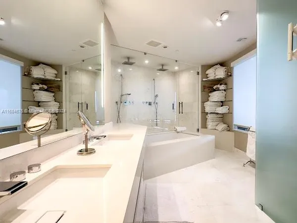 a bedroom with a large window and a bed