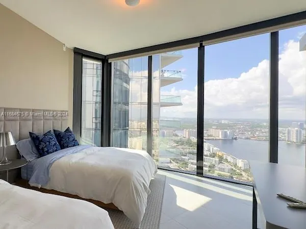 a living room with furniture and a floor to ceiling window