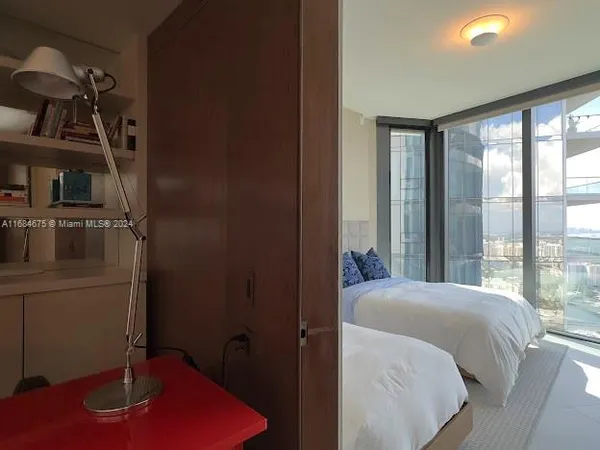 a view of staircase with lots of frames on wall and a glass door
