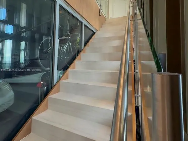 a dining room with furniture and floor to ceiling windows