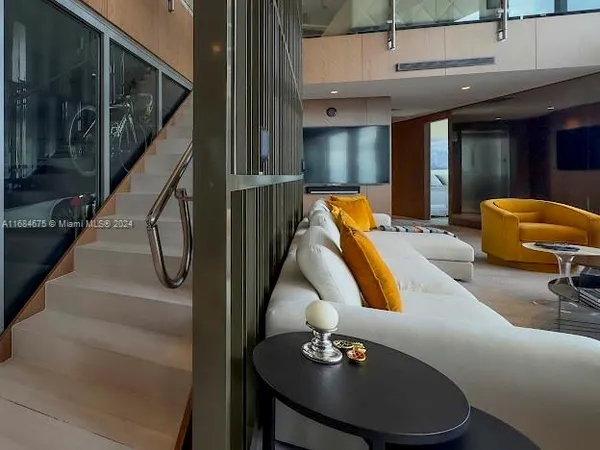 a dining room with furniture and a floor to ceiling window