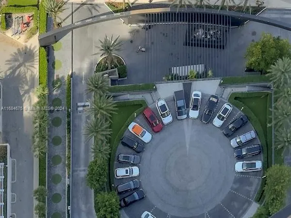 a living room with furniture tv and floor to ceiling windows