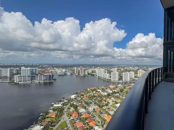 a living room with couches a coffee table and a table with garden view