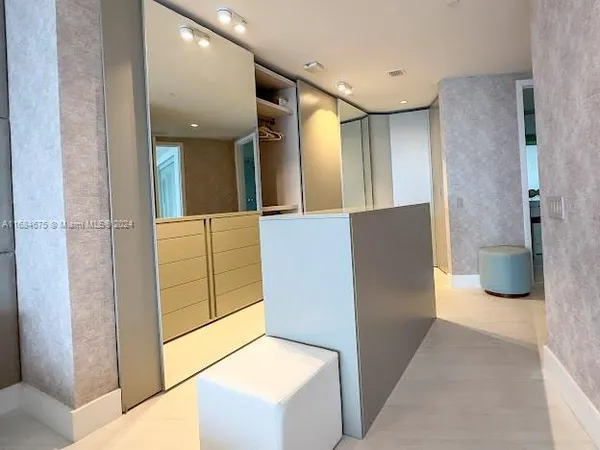 a bed room with a bed and a chair