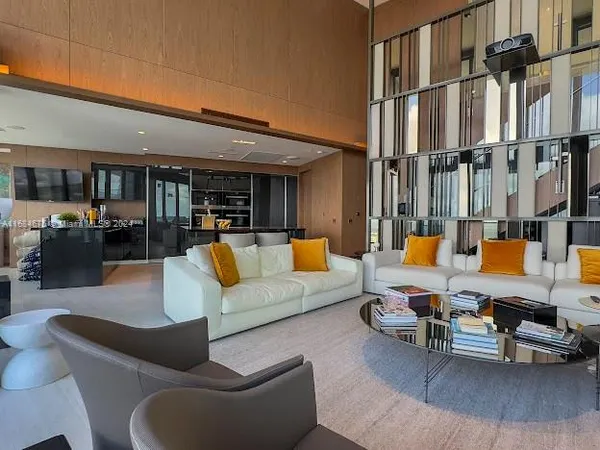 a bedroom with a large window and a bed