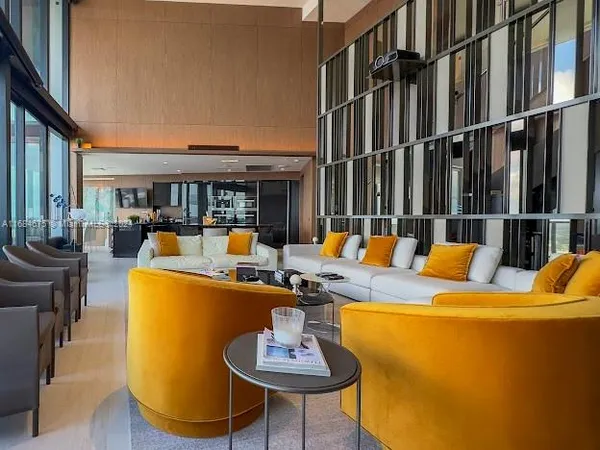 a living room with furniture and a floor to ceiling window