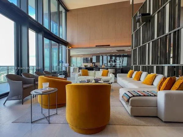 a lobby with furniture and floor to ceiling window