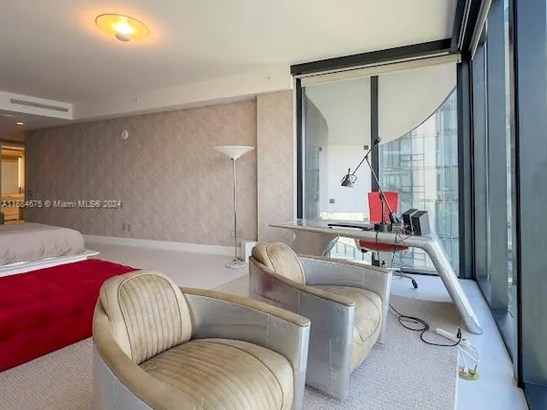 a view of living room with furniture and floor to ceiling windows