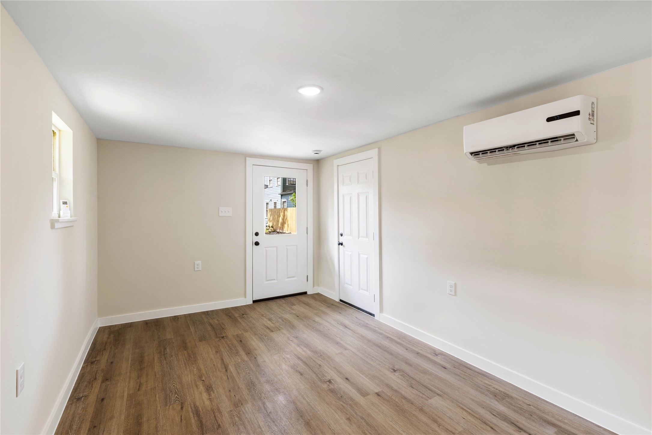 908 Key Street Houston, TX 77009 - Photo 26 of 29 Flex room with LVP flooring, New windows, mini split unit, and tankless water heater