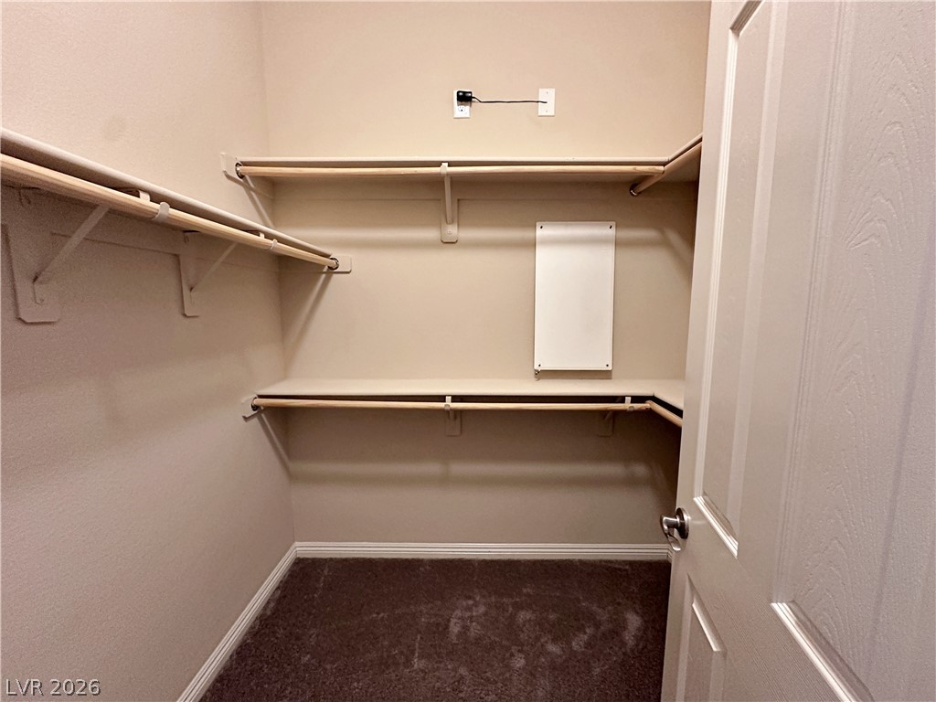 71 Newton Ridge Way Las Vegas, NV 89183 - Photo 29 of 40 Ample shelving and hanging space defines this practical, organized walk-in closet.
