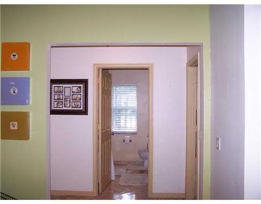 a view of an empty room with a ceiling fan