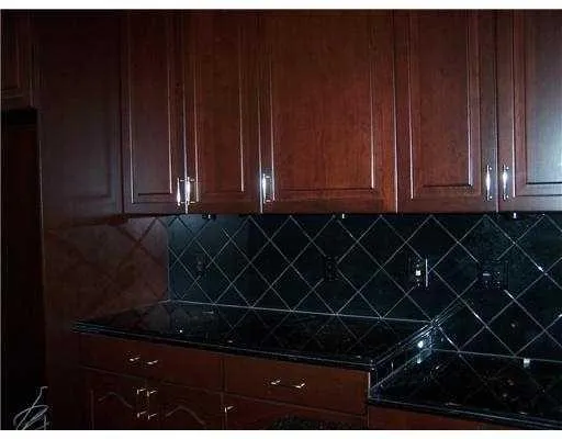 a kitchen with granite countertop a stove and a microwave