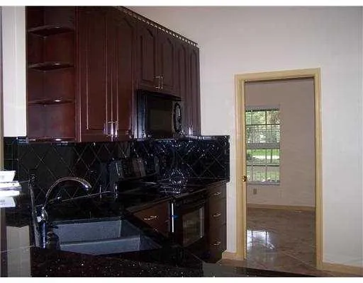 a bathroom with a sink and mirror with bathtub